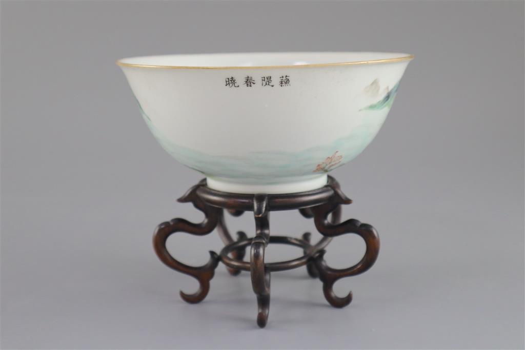 A Chinese enamelled landscape porcelain bowl, Jiaqing mark and of the period (1796-1820), 15.5cm diameter, wood stand